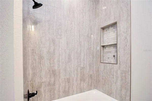 a bathroom with a bathtub and shower