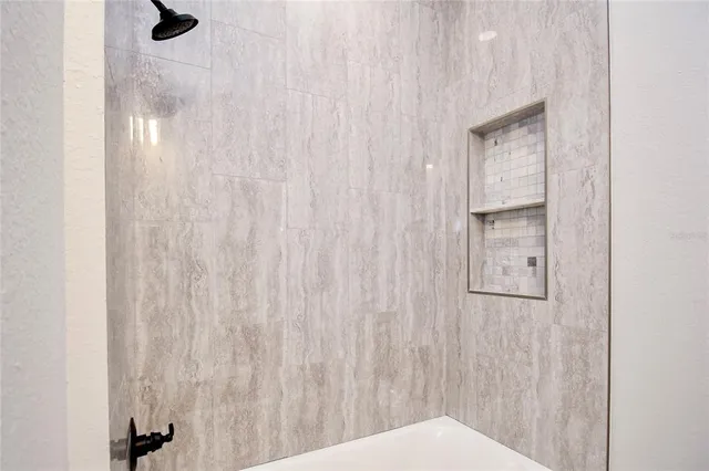 a bathroom with a bathtub and shower