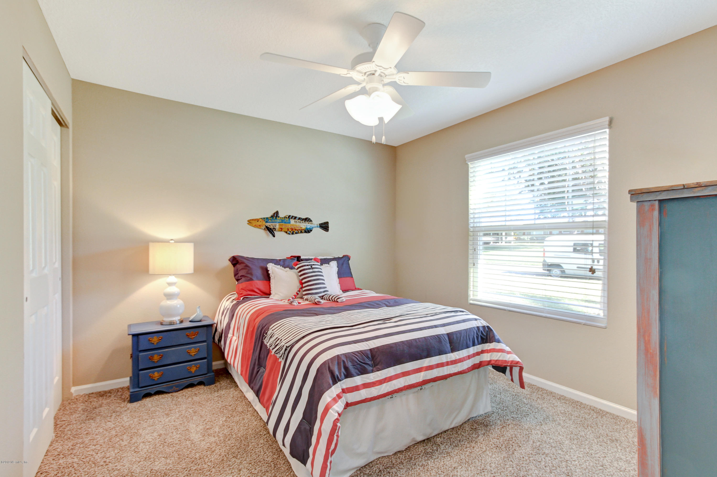 9780 Kline Road Jacksonville, FL 32246 - Photo 3 of 30 a bedroom with a bed and a chandelier