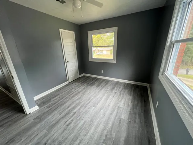 wooden floor in an empty room with a window