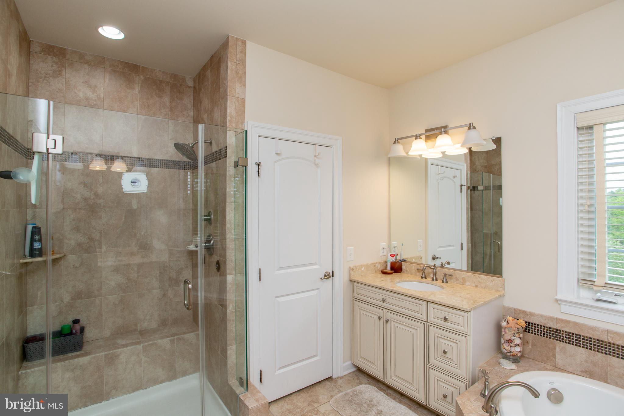 4682 Plough Tavern Road Doylestown, PA 18902 - Photo 22 of 42 a bathroom with a double vanity sink mirror double shower and a bathtub