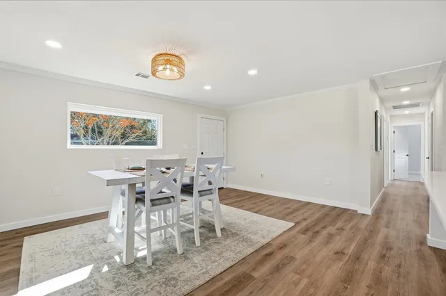a view of a dining room with furniture and a rug