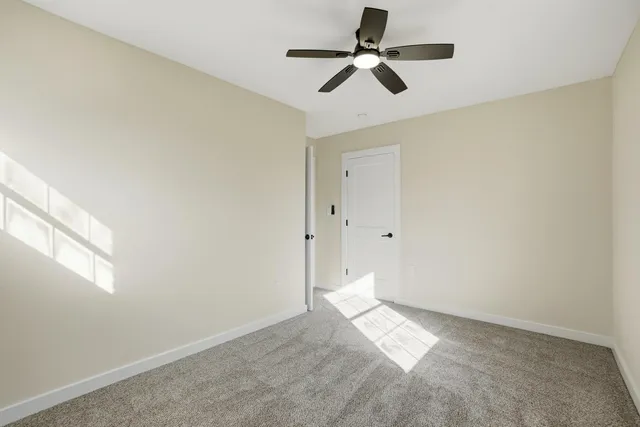 a view of empty room with ceiling fan