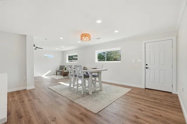 a view of a dining room with furniture and wooden floor