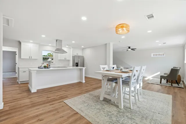 a large kitchen with a table and chairs in it