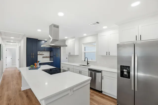 a kitchen with stainless steel appliances a refrigerator sink and microwave