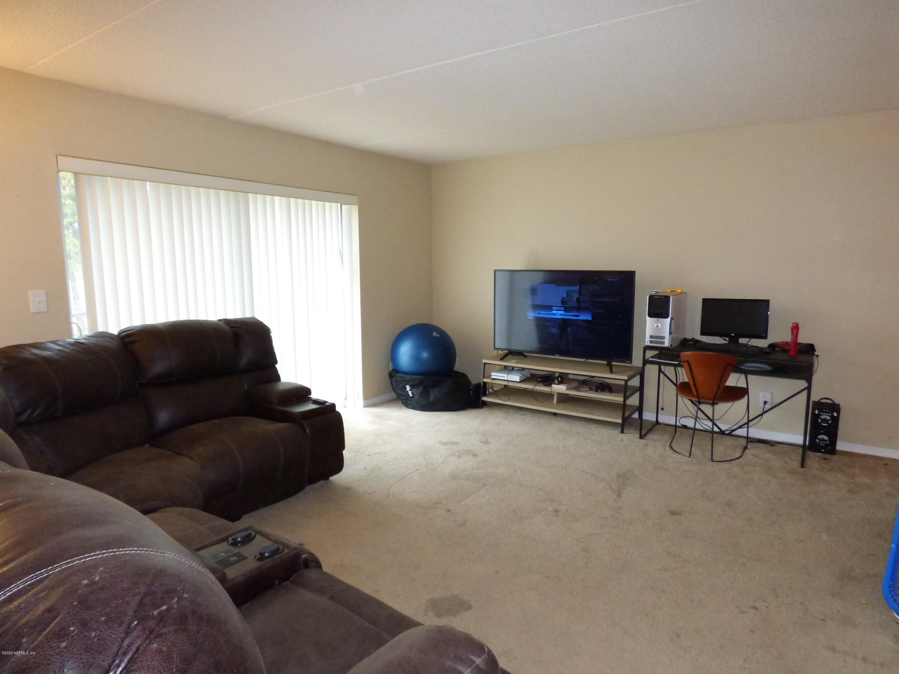 355 Monument Road, Unit 8 D2 Jacksonville, FL 32225 - Photo 4 of 19 a living room with furniture and a window
