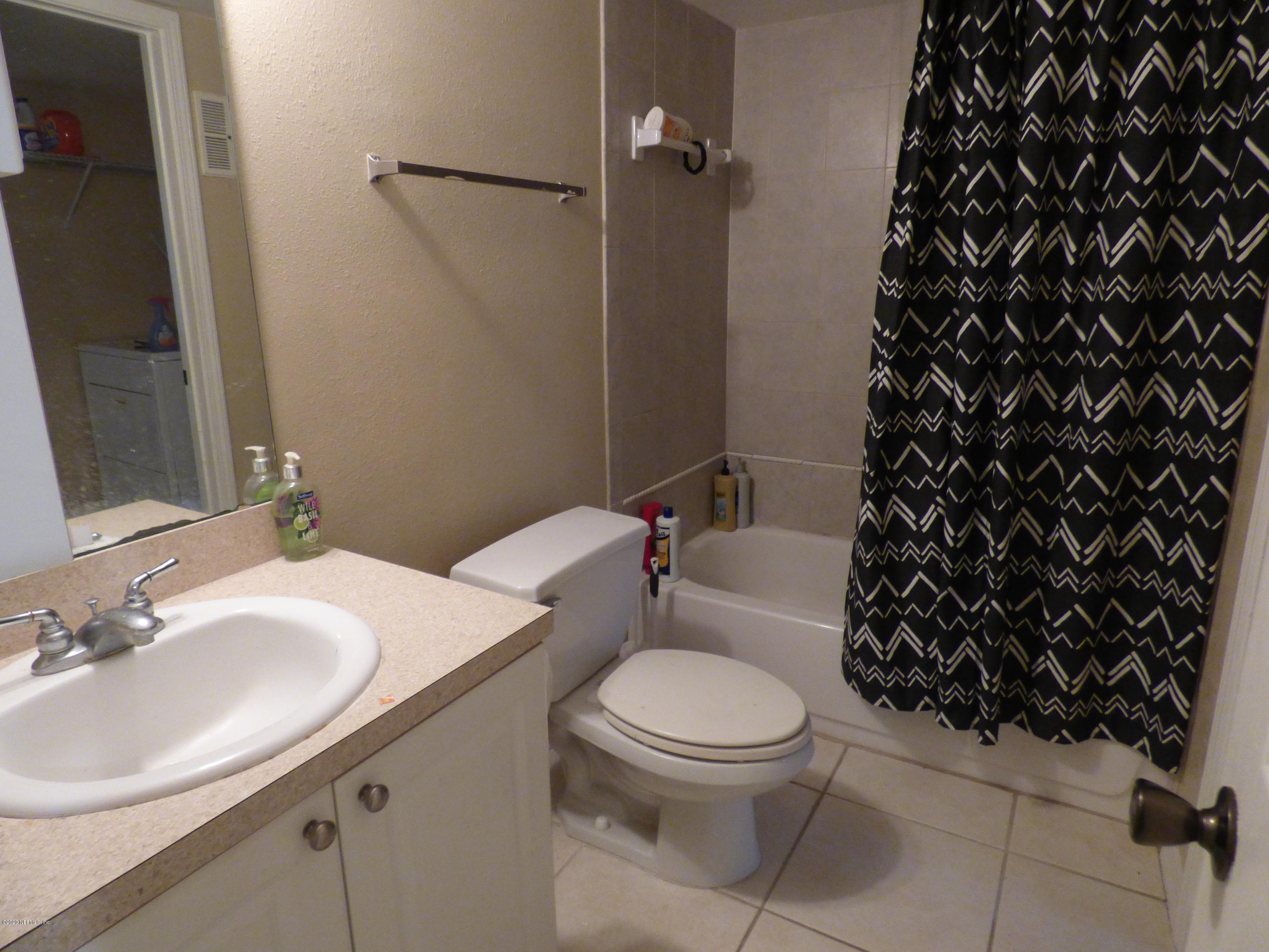 355 Monument Road, Unit 8 D2 Jacksonville, FL 32225 - Photo 8 of 19 a white toilet sitting next to a bathroom sink