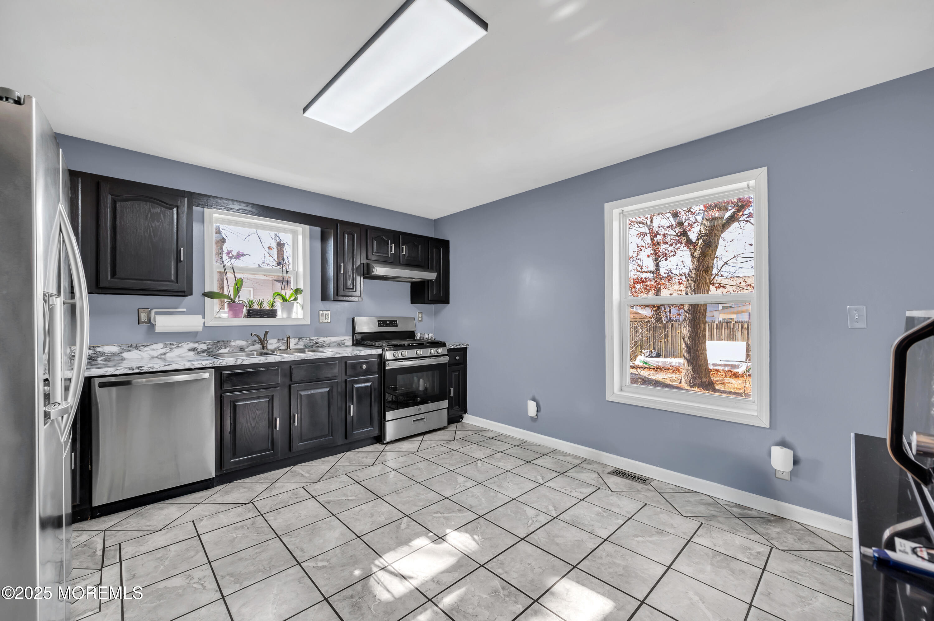 22 Liverpool Road Brick, NJ 08723 - Photo 12 of 36 a kitchen with stainless steel appliances granite countertop a stove a sink and a microwave