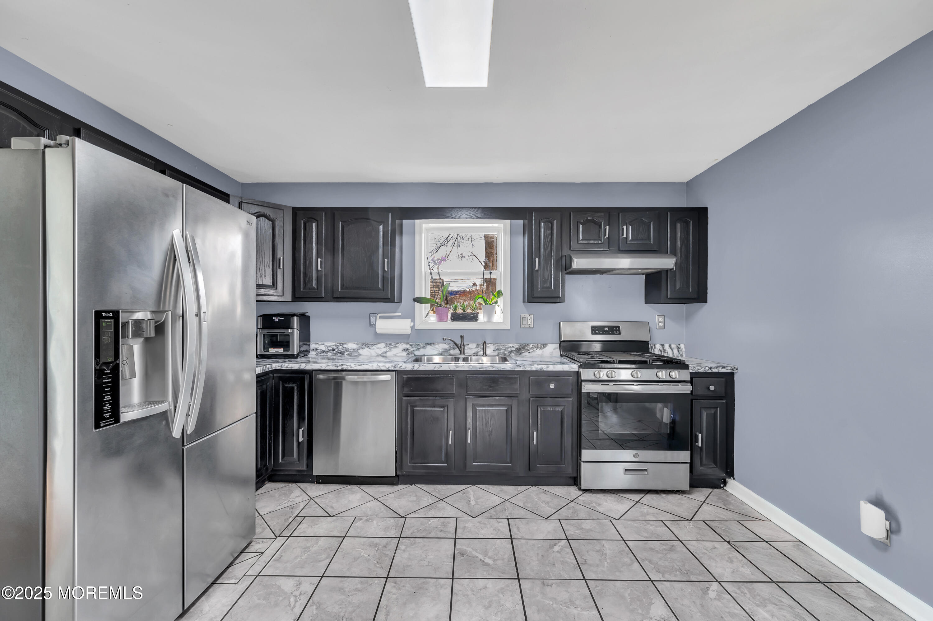 22 Liverpool Road Brick, NJ 08723 - Photo 14 of 36 a kitchen with stainless steel appliances granite countertop a stove a sink and a refrigerator