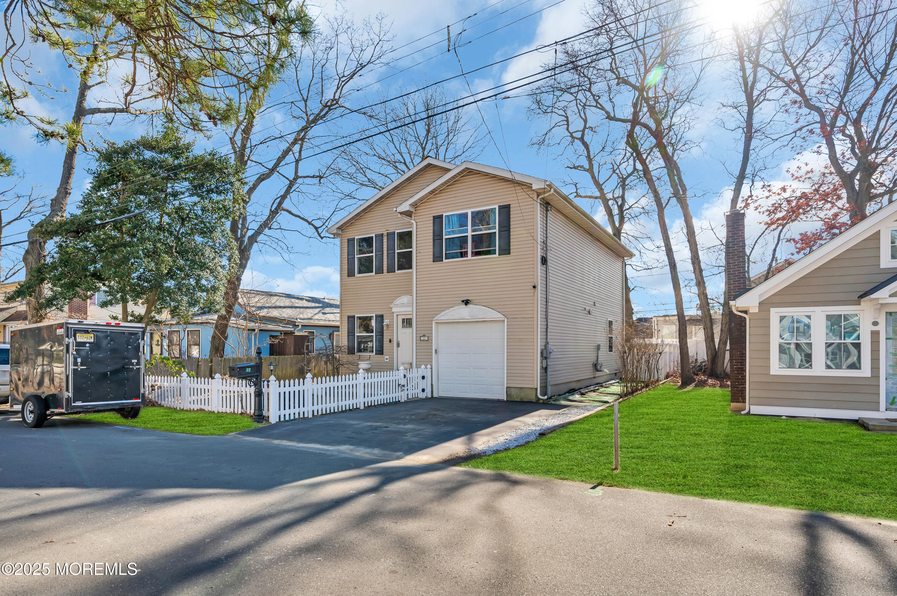 22 Liverpool Road Brick, NJ 08723 - Photo 3 of 36 a front view of a house with a yard and garage