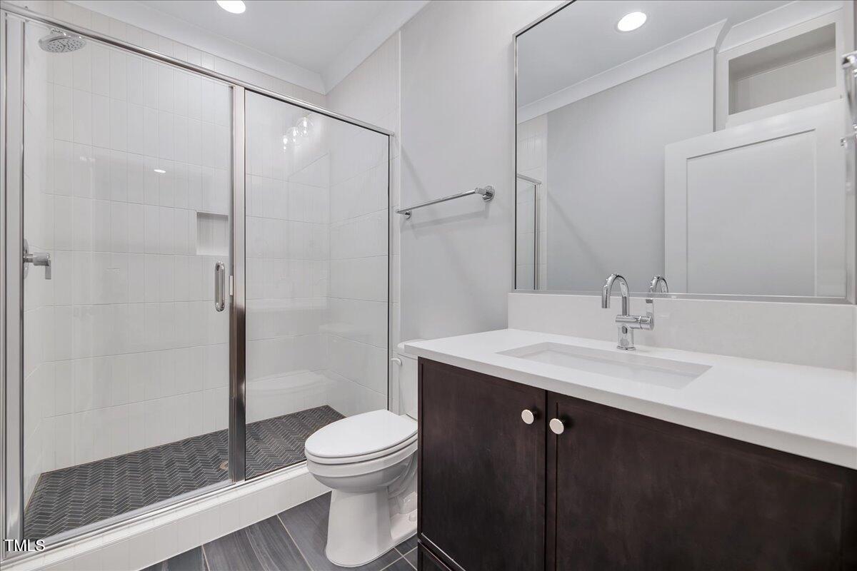 811 Maple Berry Lane, Unit 106 Raleigh, NC 27607 - Photo 27 of 30 a bathroom with a sink toilet and shower