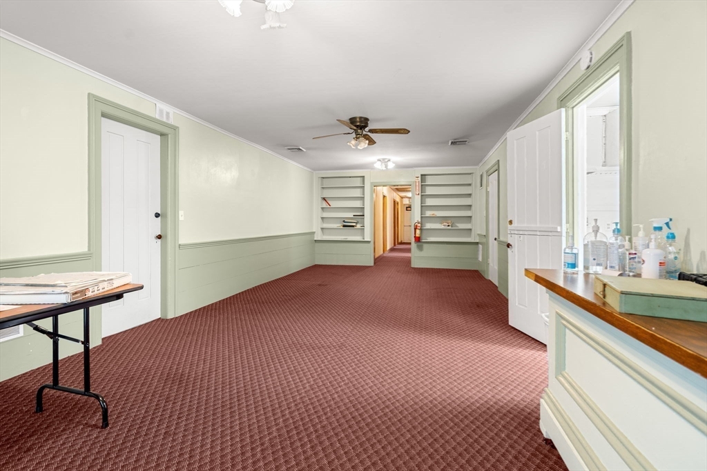 437 Main Street Southbridge, MA 01550 - Photo 17 of 31 a bedroom with a bed and a chandelier