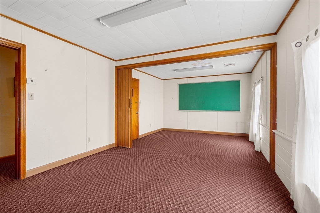 437 Main Street Southbridge, MA 01550 - Photo 21 of 31 a view of an empty room with wooden floor and a window