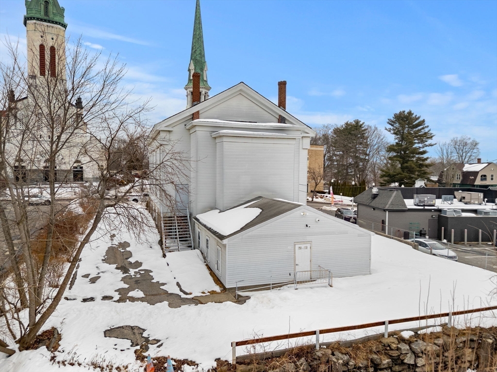 437 Main Street Southbridge, MA 01550 - Photo 4 of 31 a view of a white house with a yard