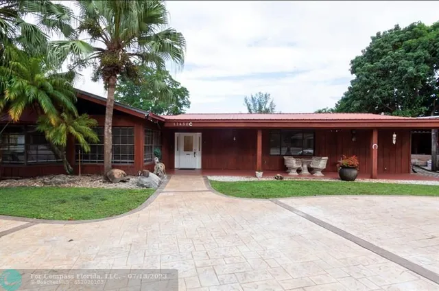 a front view of a house with a yard and porch