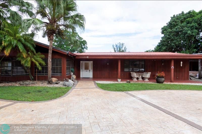 a front view of a house with a yard and porch