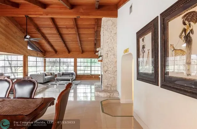 a kitchen with stainless steel appliances kitchen island granite countertop a sink a stove a refrigerator a dining table and chairs