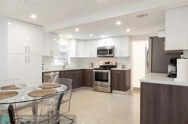 a kitchen with a sink stove and microwave