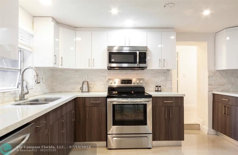 11450 Southwest 17th Street Davie, FL 33325 - Photo 15 of 56 a kitchen with a sink stove and microwave