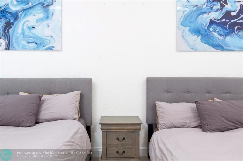 11450 Southwest 17th Street Davie, FL 33325 - Photo 20 of 56 a large bed sitting in a bedroom and painting on the wall