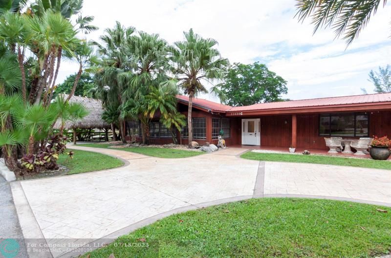 11450 Southwest 17th Street Davie, FL 33325 - Photo 2 of 56 a view of a house with a yard and plants