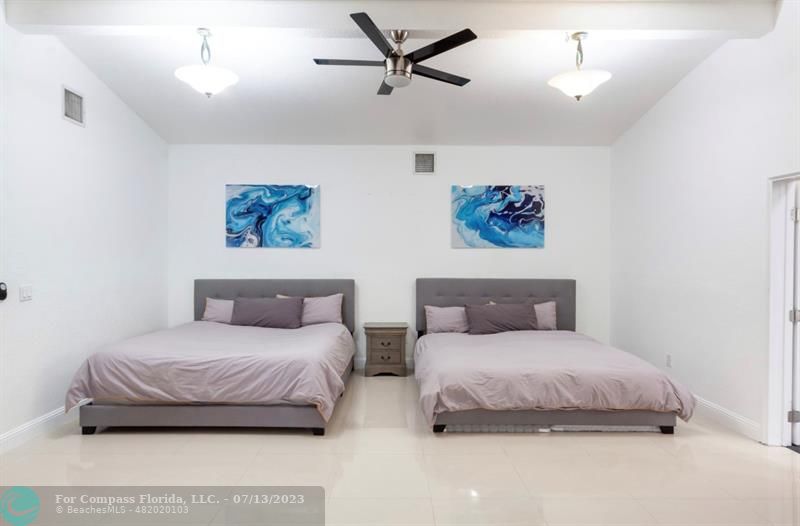 11450 Southwest 17th Street Davie, FL 33325 - Photo 24 of 56 a bedroom with a bed and a painting on the wall