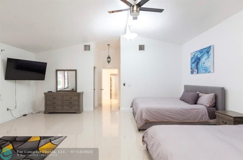 11450 Southwest 17th Street Davie, FL 33325 - Photo 26 of 56 a bedroom with a bed and flat screen tv