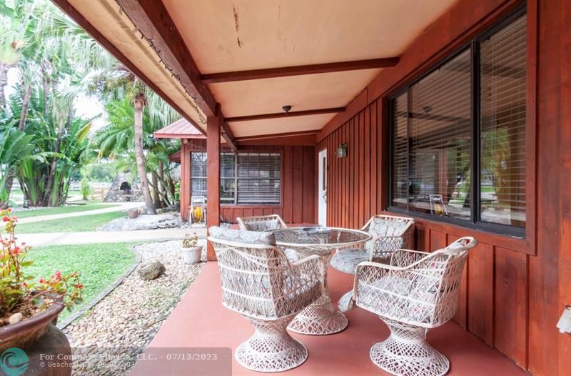 11450 Southwest 17th Street Davie, FL 33325 - Photo 4 of 56 a outdoor space with patio the couches and a dining table with garden view