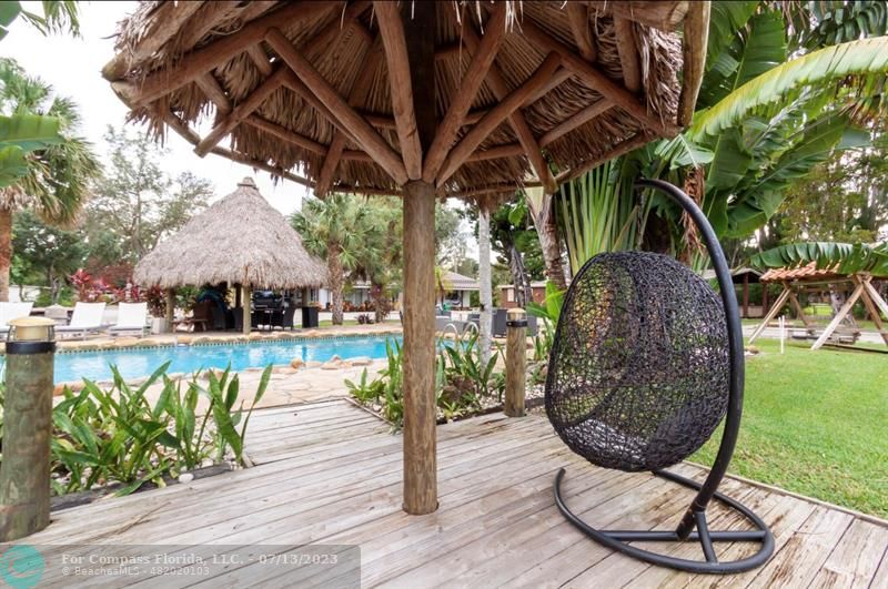 11450 Southwest 17th Street Davie, FL 33325 - Photo 50 of 56 a view of a swimming pool with a patio and a yard