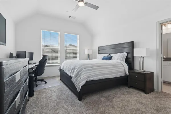 a bedroom with a bed and a desk
