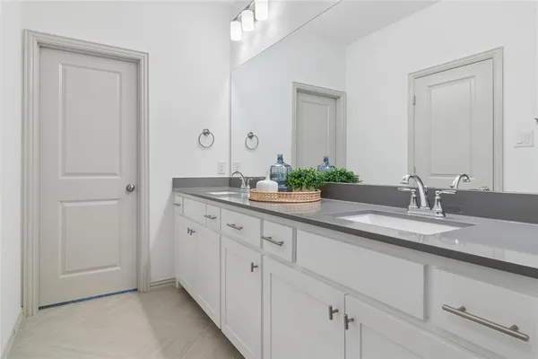 a bathroom with a granite countertop sink a toilet and shower
