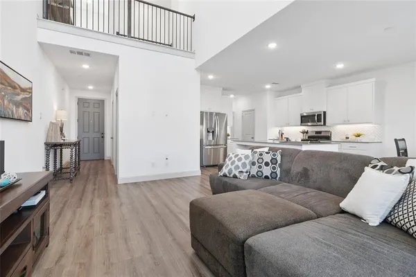 a living room with furniture and kitchen view
