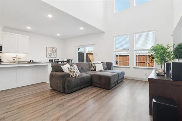 a living room with fireplace furniture and a wooden floor