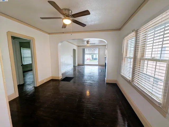 wooden floor in an empty room with a window