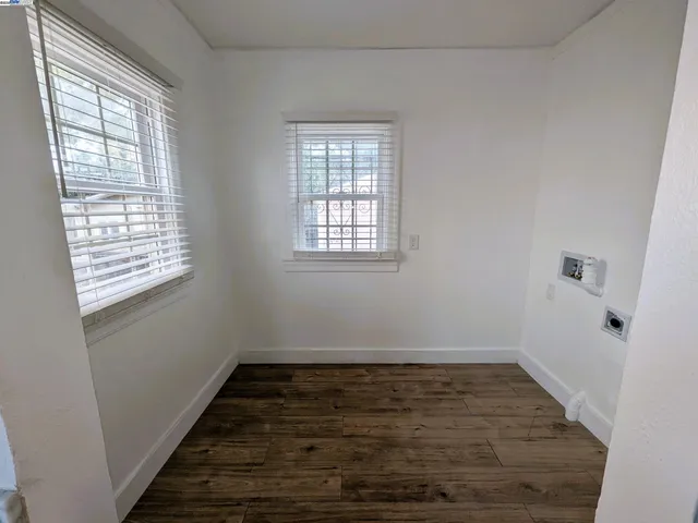 a view of a room with wooden floor and window