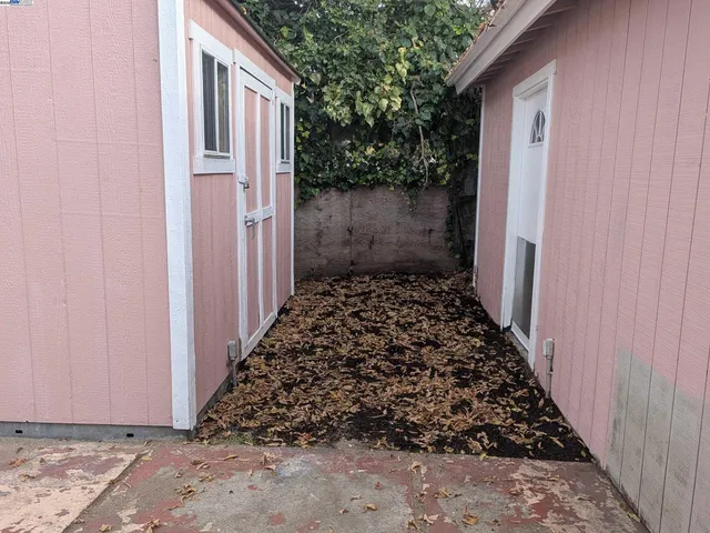 a view of a pathway gate and yard