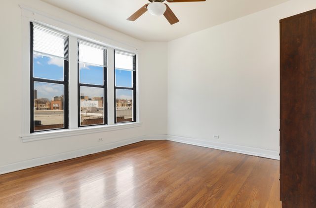 2961 North Halsted Street, Unit 3 Chicago, IL 60657 - Photo 12 of 19 an empty room with wooden floor and windows