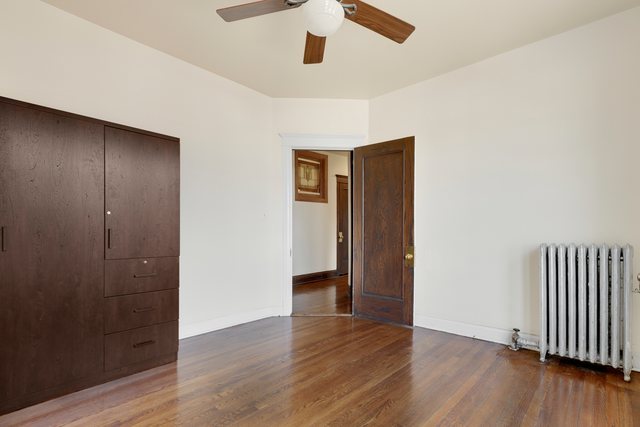 2961 North Halsted Street, Unit 3 Chicago, IL 60657 - Photo 13 of 19 an empty room with wooden floor and windows