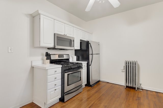2961 North Halsted Street, Unit 3 Chicago, IL 60657 - Photo 15 of 19 a kitchen with a stove microwave and a refrigerator