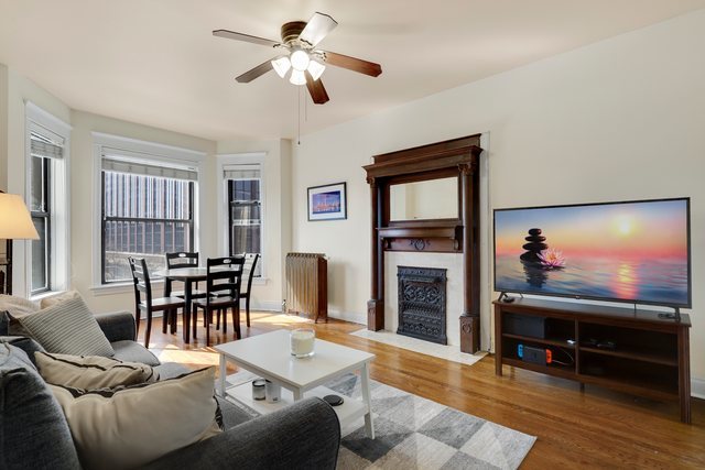2961 North Halsted Street, Unit 3 Chicago, IL 60657 - Photo 3 of 19 a view of a livingroom with furniture and a flat screen tv