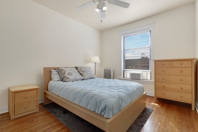 2961 North Halsted Street, Unit 3 Chicago, IL 60657 - Photo 8 of 19 a bedroom with a bed and a dresser