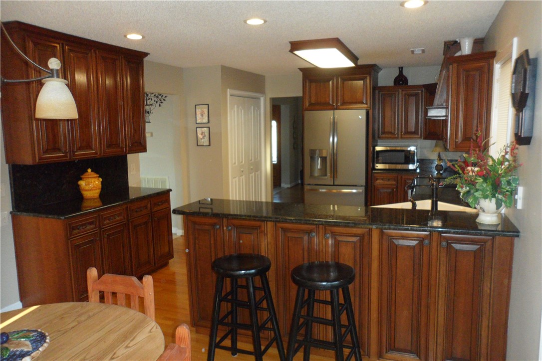 435 Cane Creek Landing Road, Unit SENECA Seneca, SC 29672 - Photo 19 of 43 Beautiful cherry cabinets, bar with extra storage,