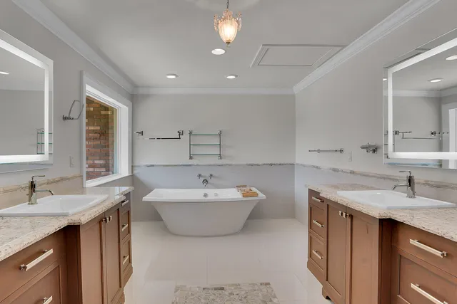 a spacious bathroom with a sink double vanity mirror and bathtub