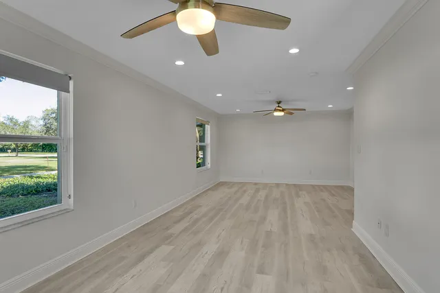 a bathroom with a granite countertop sink a toilet a mirror and shower