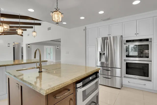 a bathroom with a granite countertop sink a toilet and shower