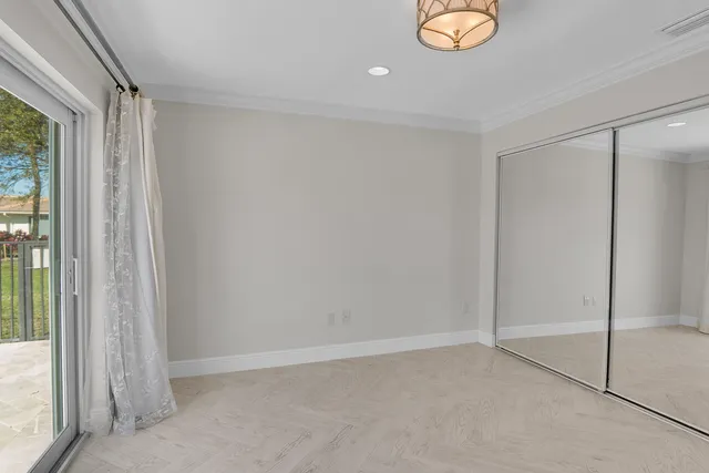 a bathroom with a granite countertop sink and a refrigerator