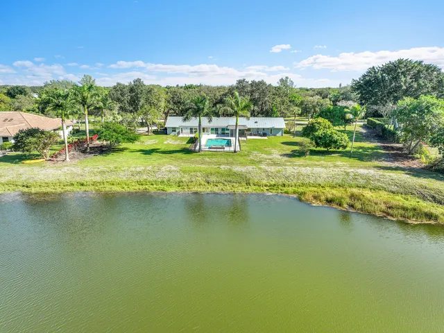 a view of a lake with houses in the back