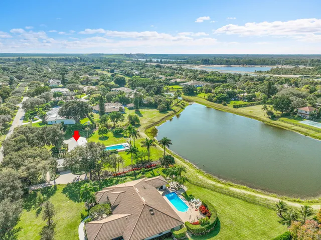 an aerial view of residential houses with outdoor space and swimming pool