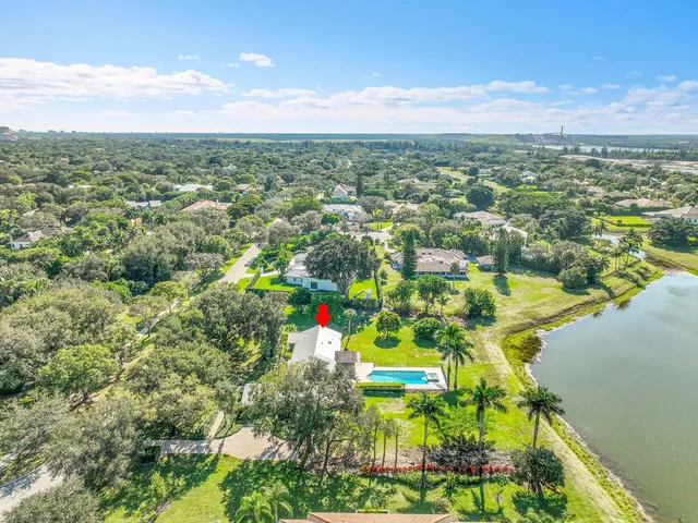 a view of a house with a big yard and sitting area